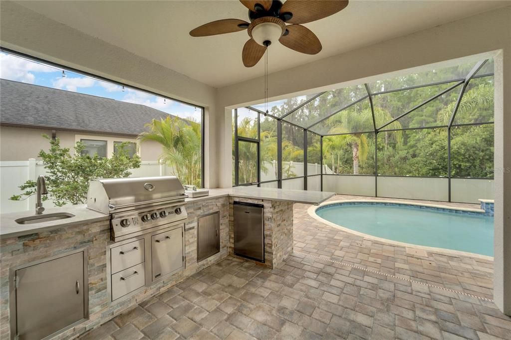 ENJOY A NEW OUTDOOR KITCHEN WITH GRILL, SINK, REFRIGERATOR AND STORAGE FOR GREAT AL FRESCO MEALS AND ENTERTAINING!