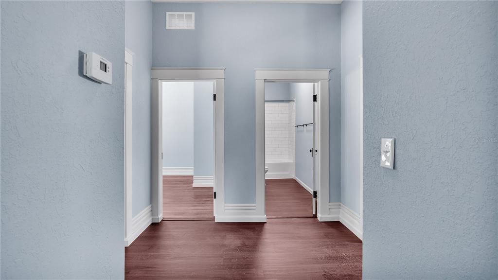 Hallway to two bedrooms and bathroom