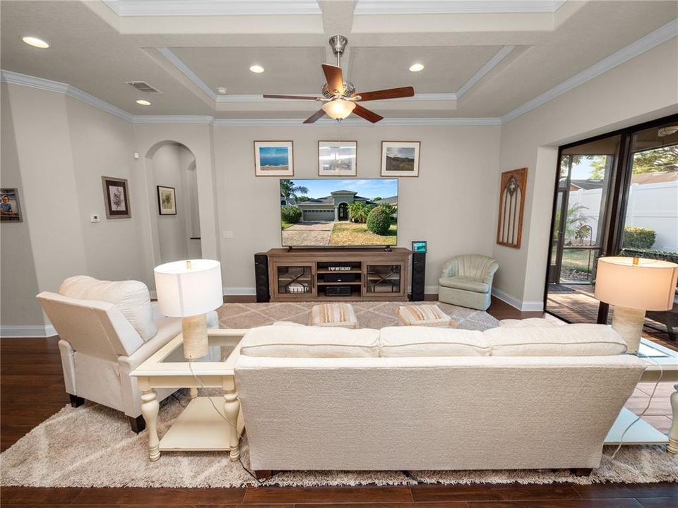 Great Room with Coffered Ceiling Open to Kitchen and Screened Lanai