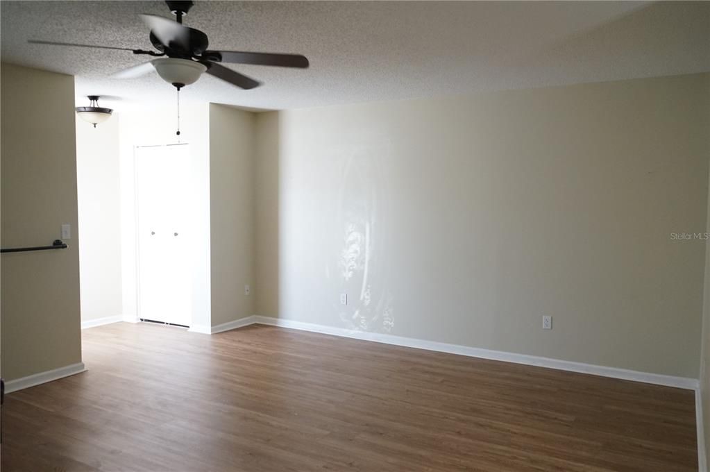 entry has a coat closet and laminate floors in living room