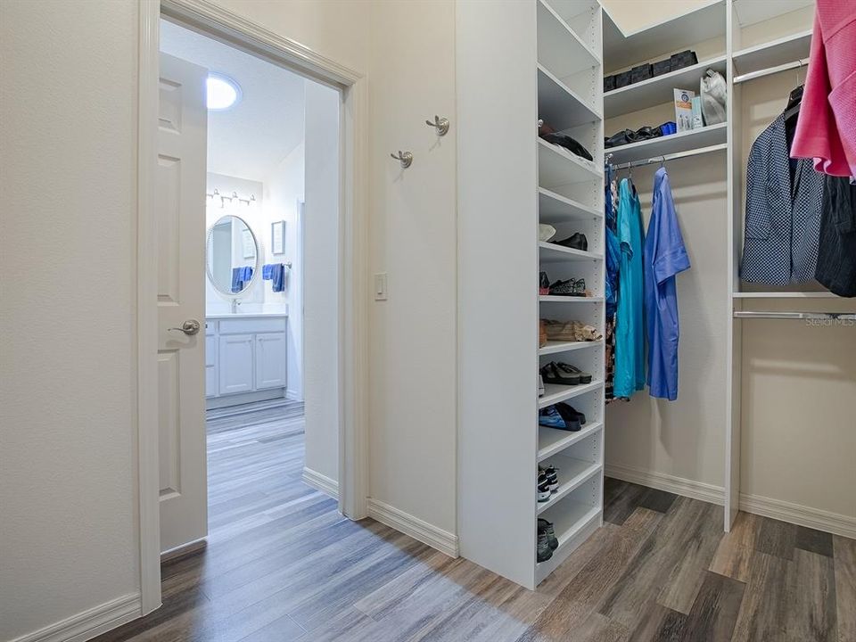 ANOTHER POCKET DOOR OPENS TO THE SPACIOUS WALK-IN CLOSET WITH BUILTS-INS.