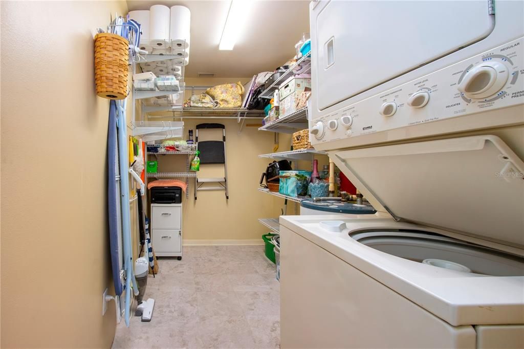 Large utility room with stack washer/dryer and new vinyl flooring