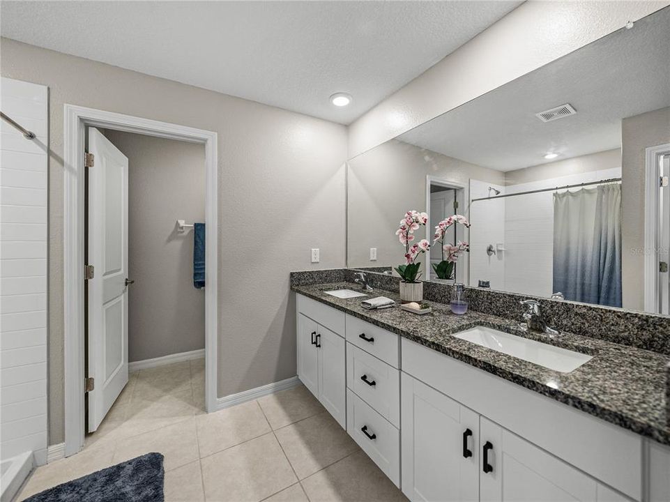Master Bath with dual sinks, separate toilet room, linen closet and walk in shower.