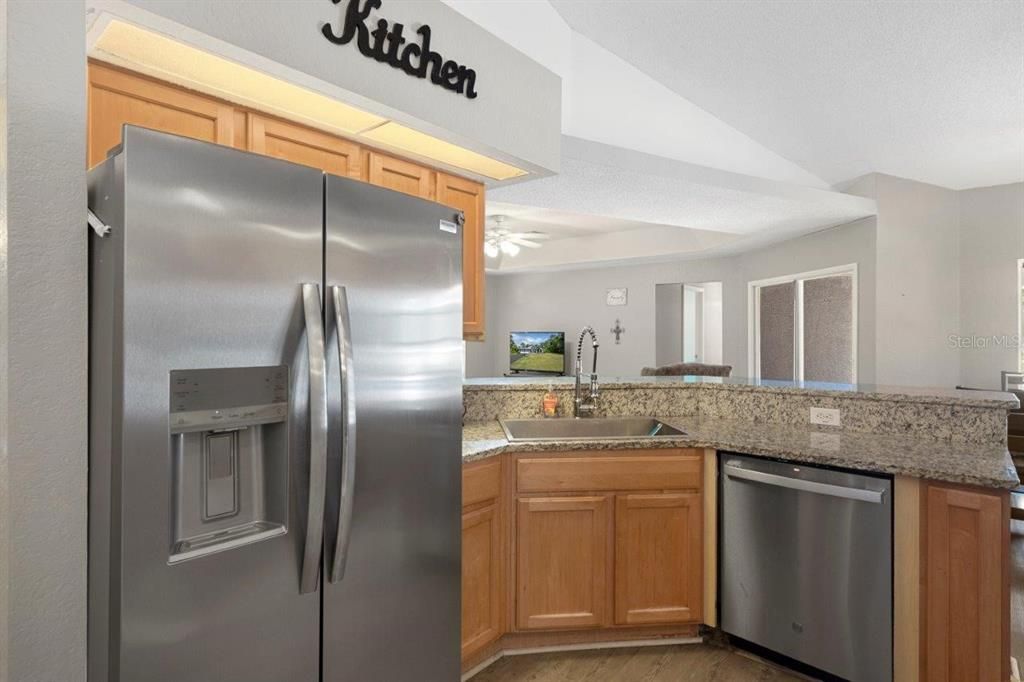 Spacious kitchen featuring granite countertops, stainless steel appliances, and a pantry.