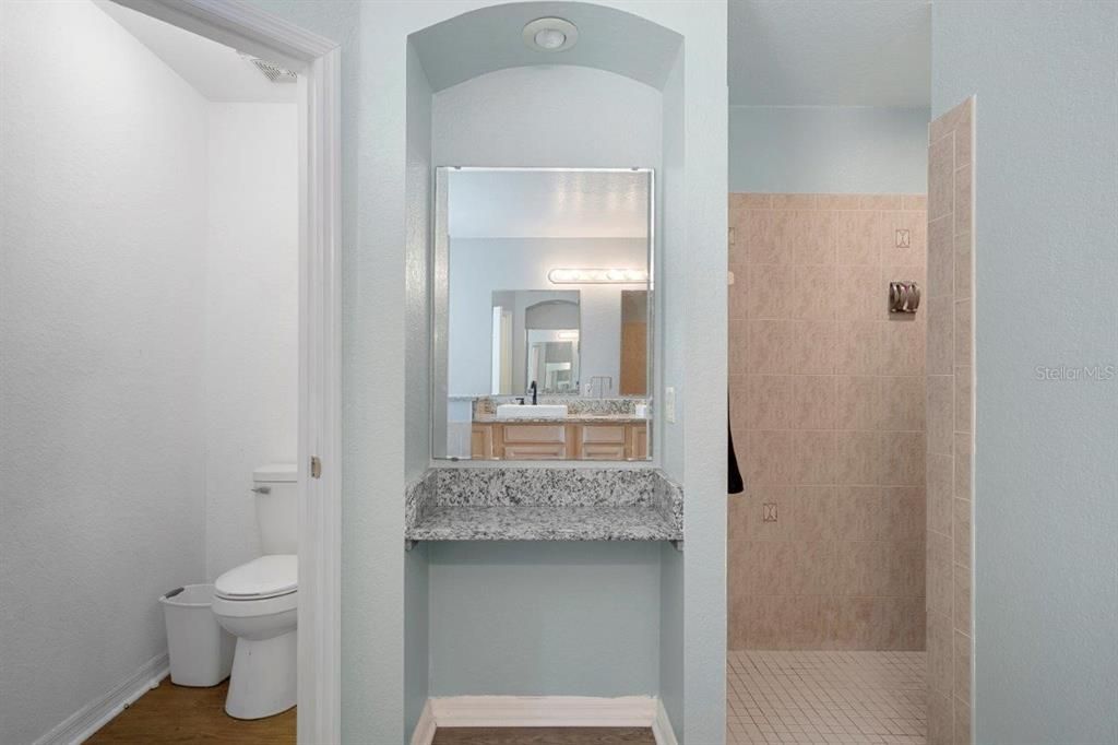 Owners ensuite bathroom with dual sinks, a garden tub, and walk-in shower.