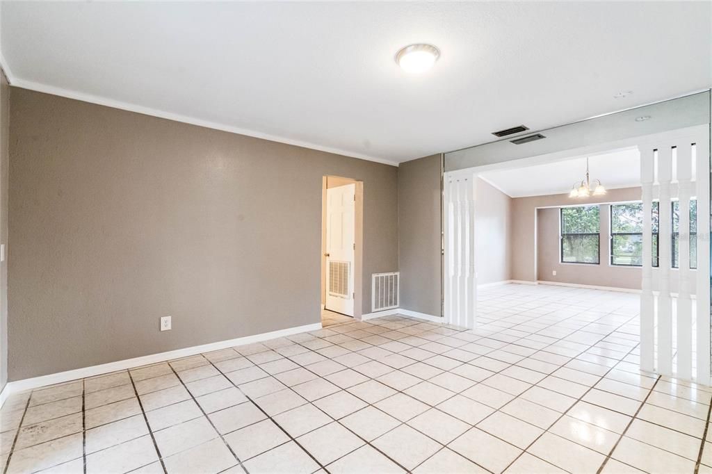 Formal dining room/living room with entrance to kitchen