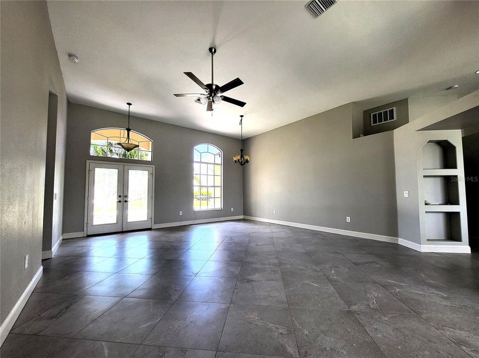 Tall windows and leaded glass double entry doors add an abundance of natural lighting.