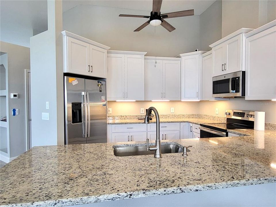 Staggered height cabinets, with crown molding and soft-close doors.