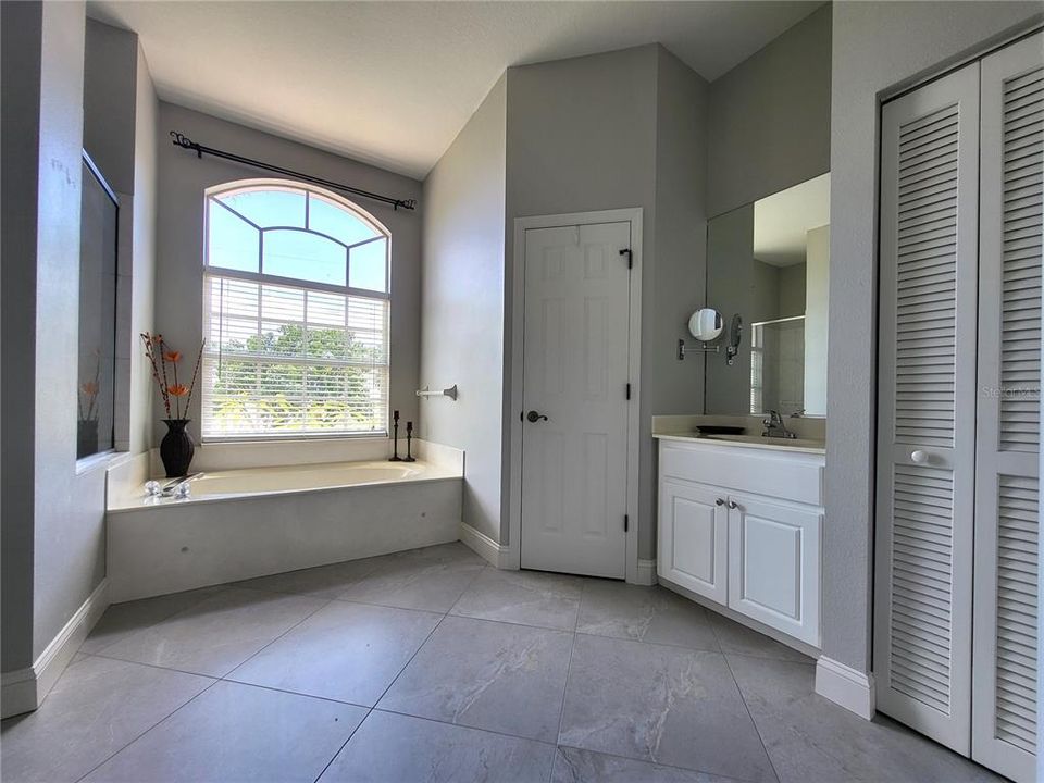 Linen closet on the right. Toilet is behind the door in center.