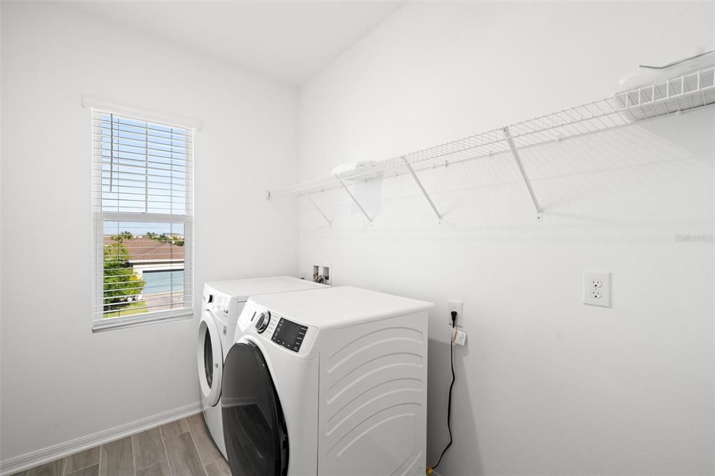 Large laundry room with window for natural light and additional storage