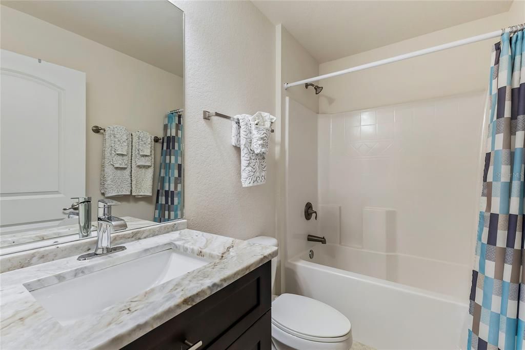 Guest Bathroom w/ Granite Counters, and a Tub/Shower Combo