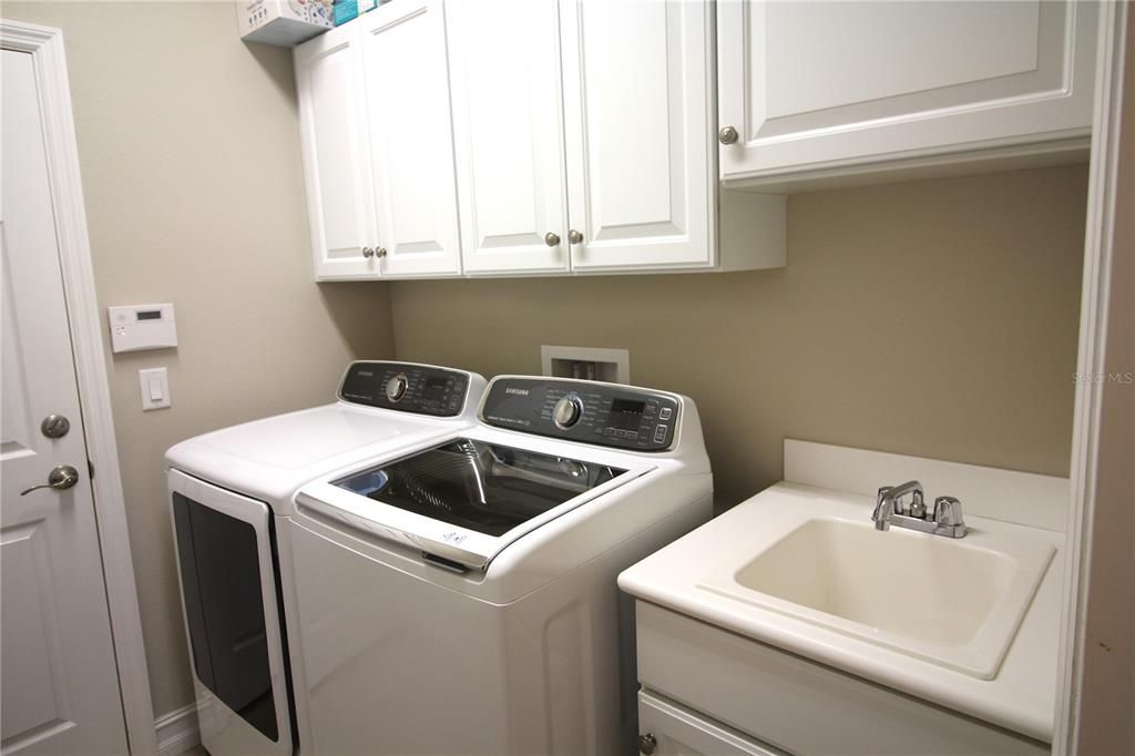Laundry with cabinets and sink