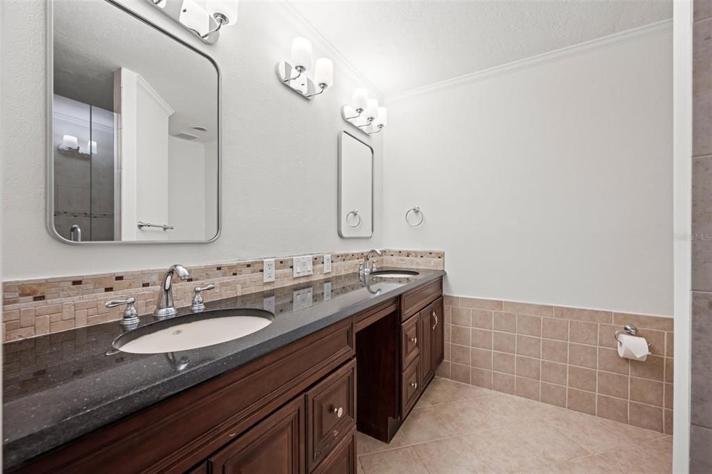 Primary Bath with granite countertop, new lighting, new mirrors & dual sinks