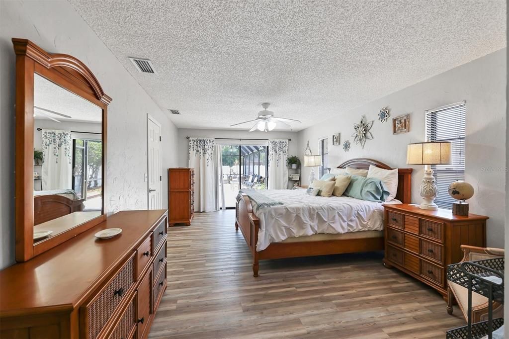 Master Bedroom with Sliding Glass doors out to the Pool.