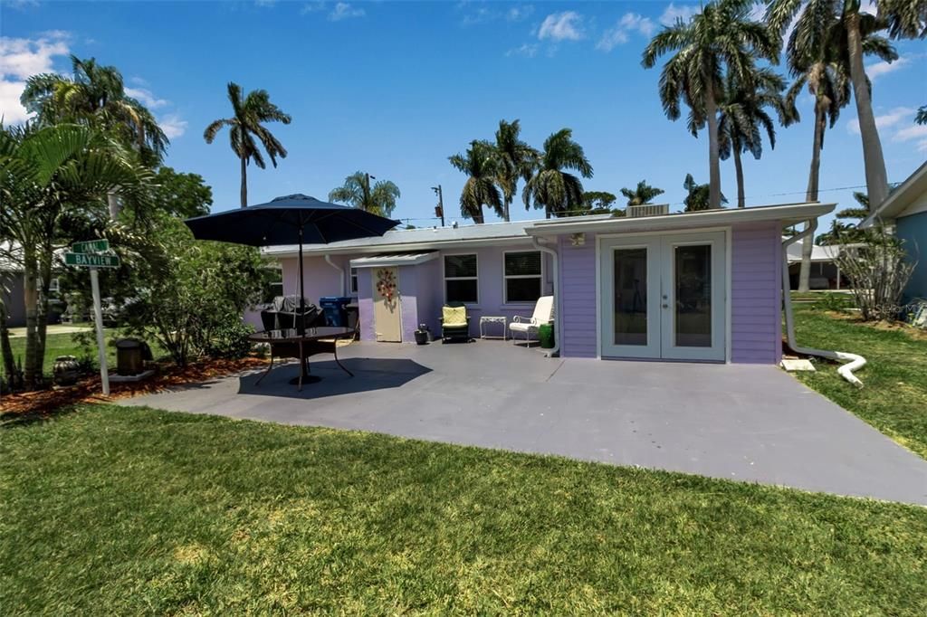 Concrete patio with metal-roofed shed.