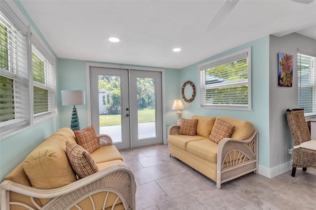 Additional seating space with French doors to backyard.