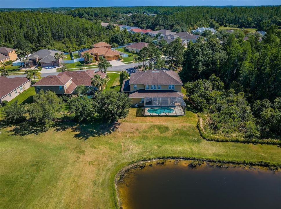Aerial of rear of home, pond and golf course