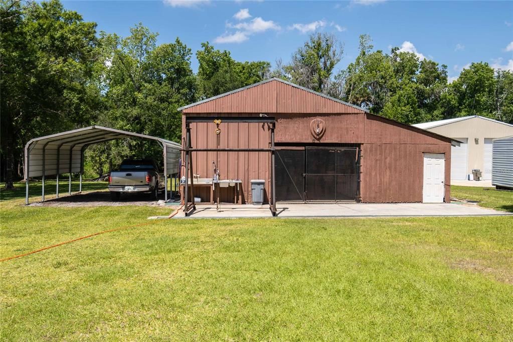 Barn/Workshop with double carport to the left.