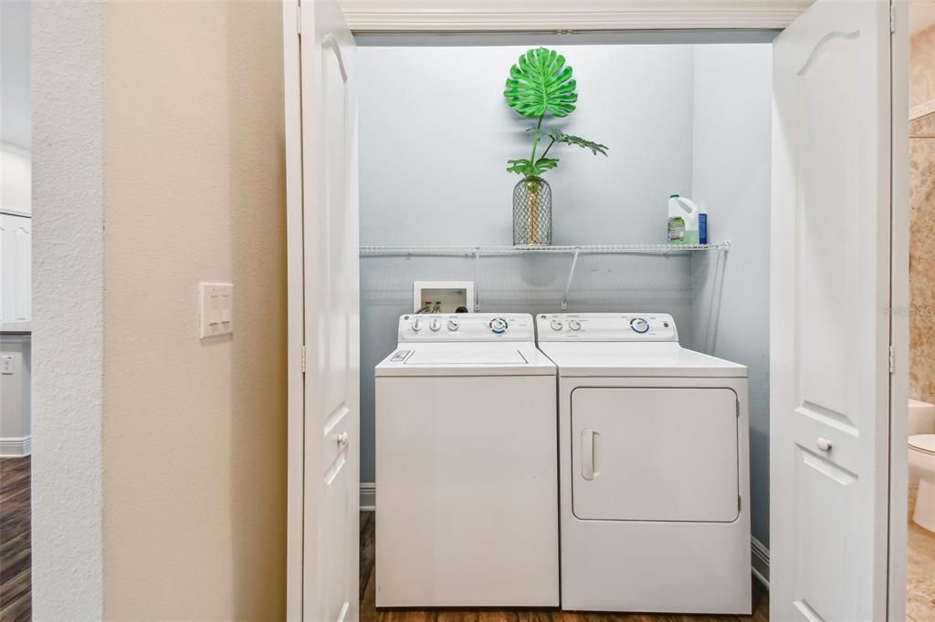 Spacious laundry area with GE washer and dryer.