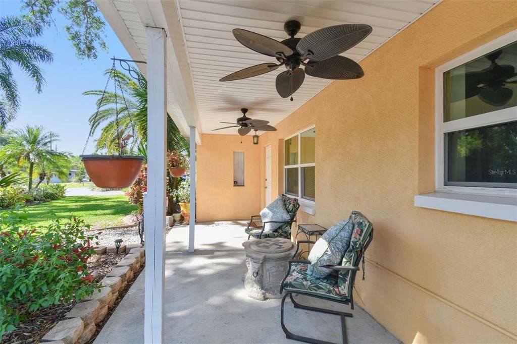 Large covered front porch with ceiling fans, perfect for long summer evening