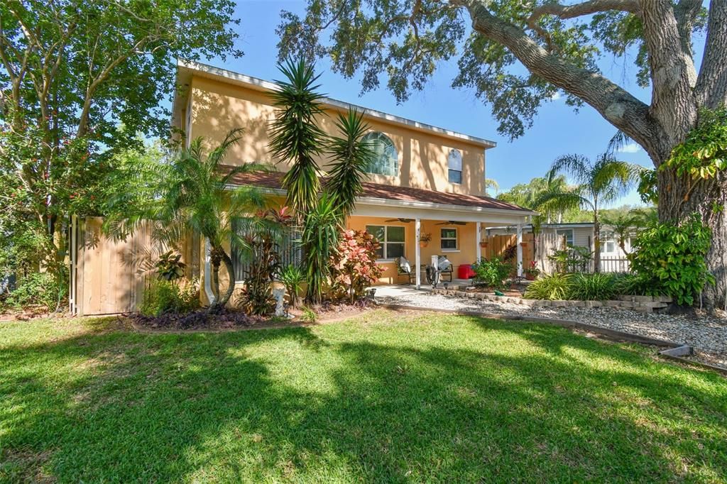 Surrounded by beautiful landscaping and gorgeous shade tree.