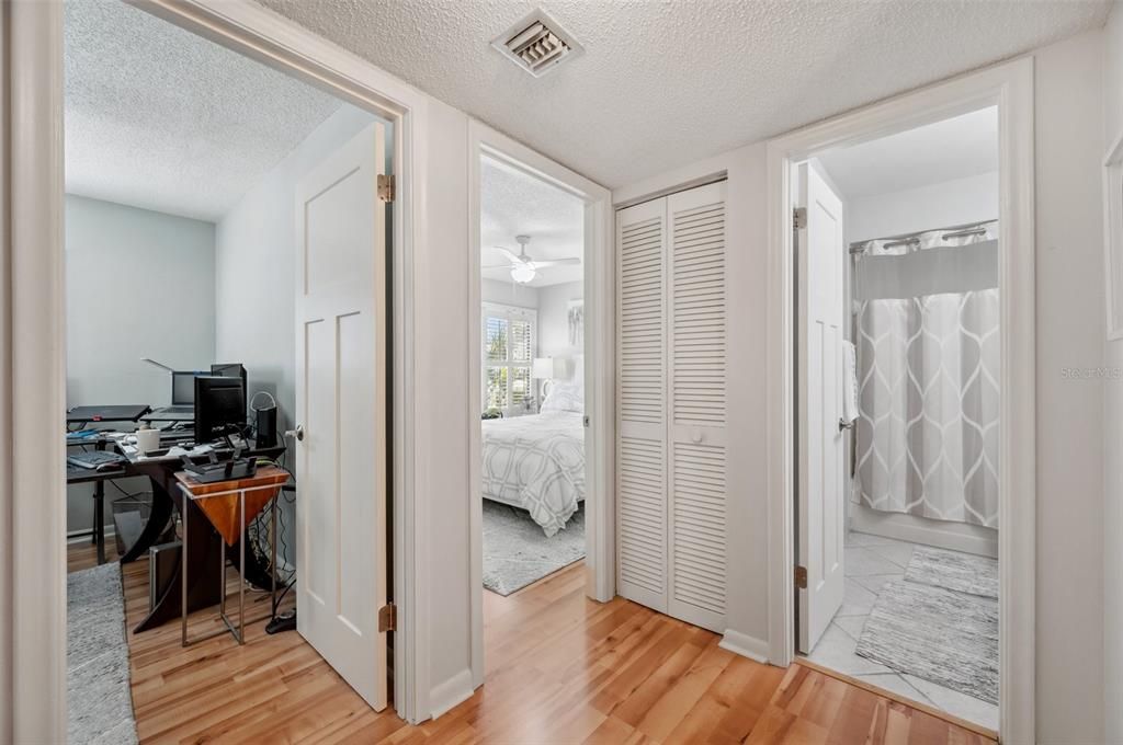 Hall with doors to both bedrooms and first bathroom