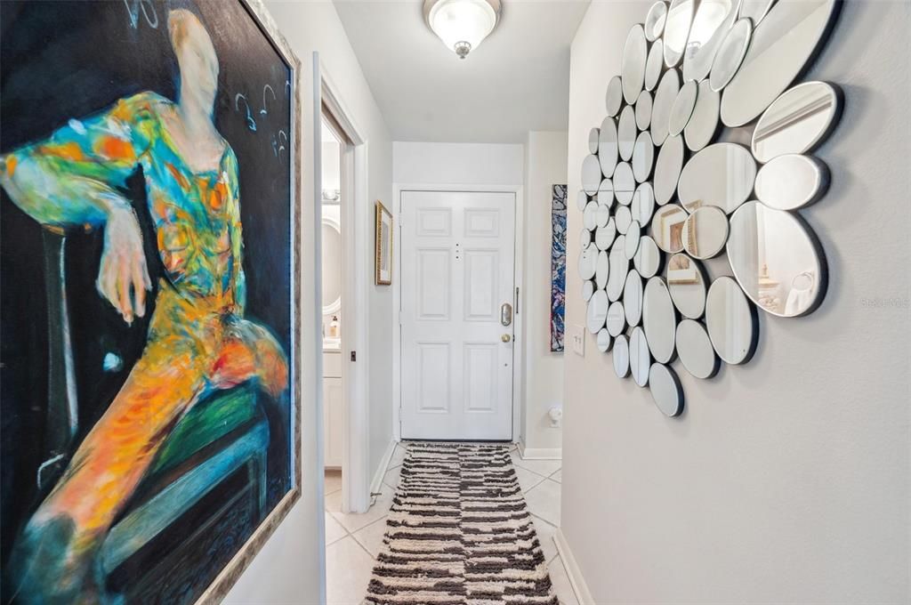 Entrance hall to front door, left side half bath, and also nice storage under the stairs!