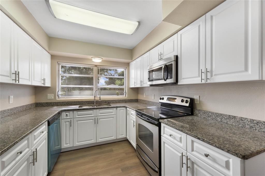 This charming home offers an ideal SPLIT BEDROOM LAYOUT, UPDATED BATHROOMS and the comfortable kitchen has STAINLESS STEEL APPLIANCES and a modern color palette reflected in the cabinets and countertops.