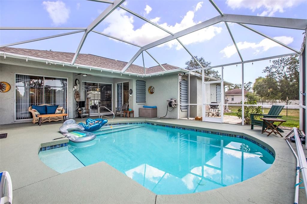 Heated pool and spacious lanai, perfect for entertaining and relaxation.