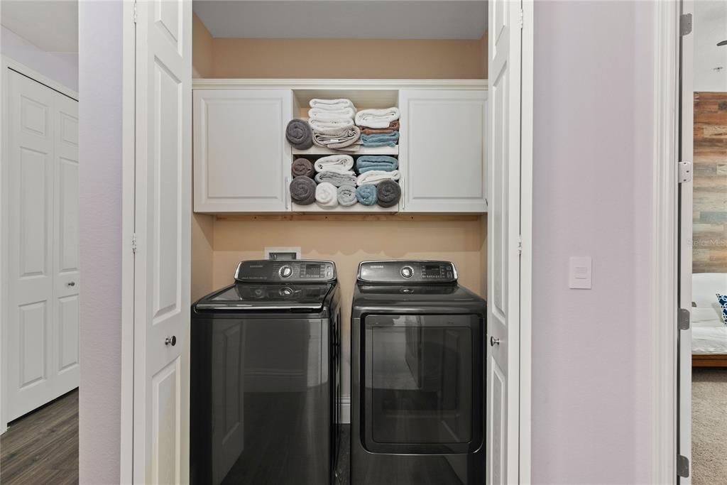 Laundry with built in cabinets.