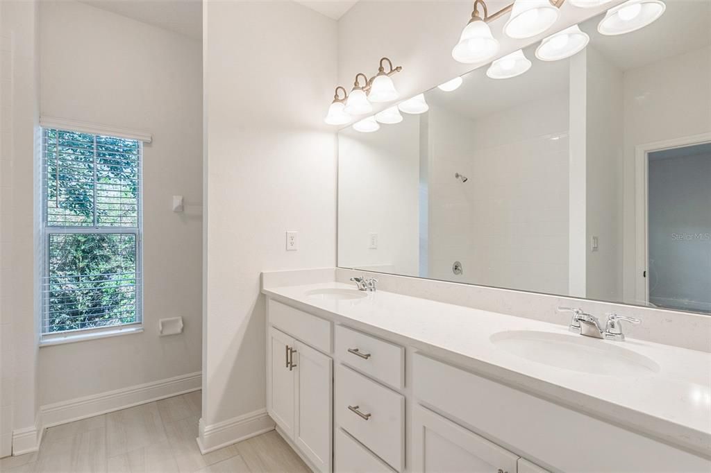 Double vanities in the primary bathroom make getting ready a breeze!