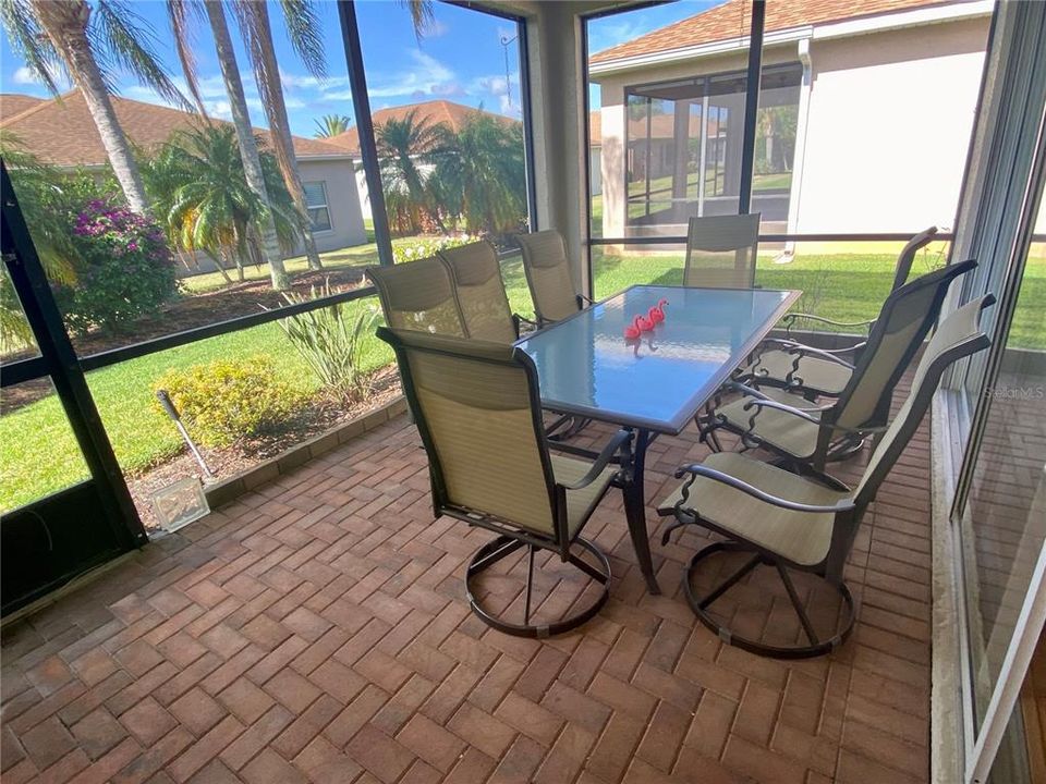 Lanai with outdoor furniture and privacy from lush landscaping