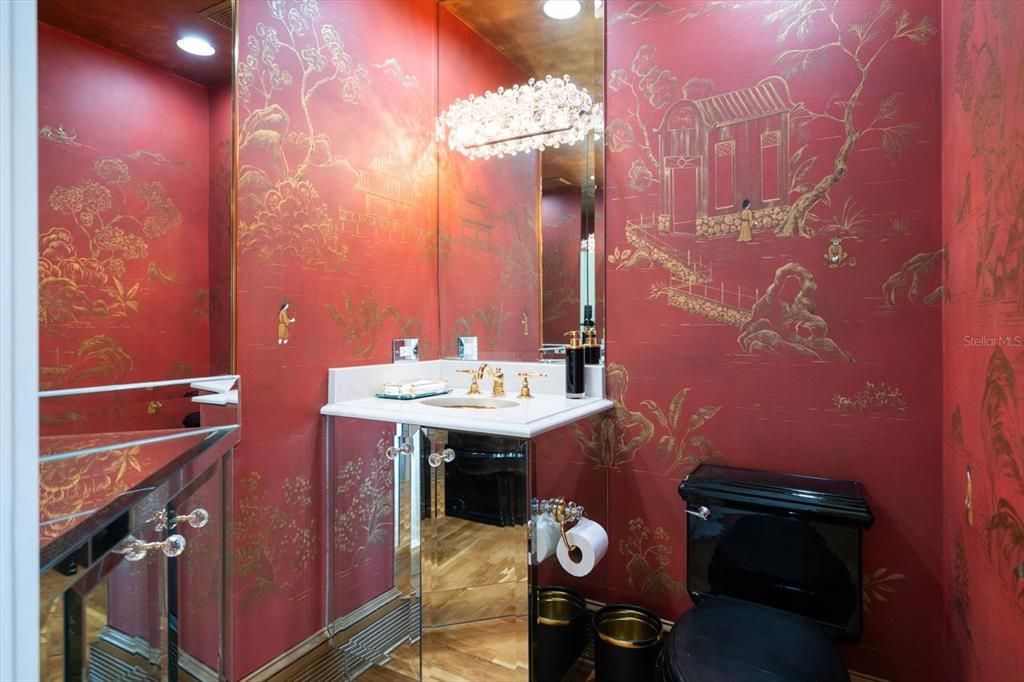 Elegant powder room off the living room with hand-painted walls.