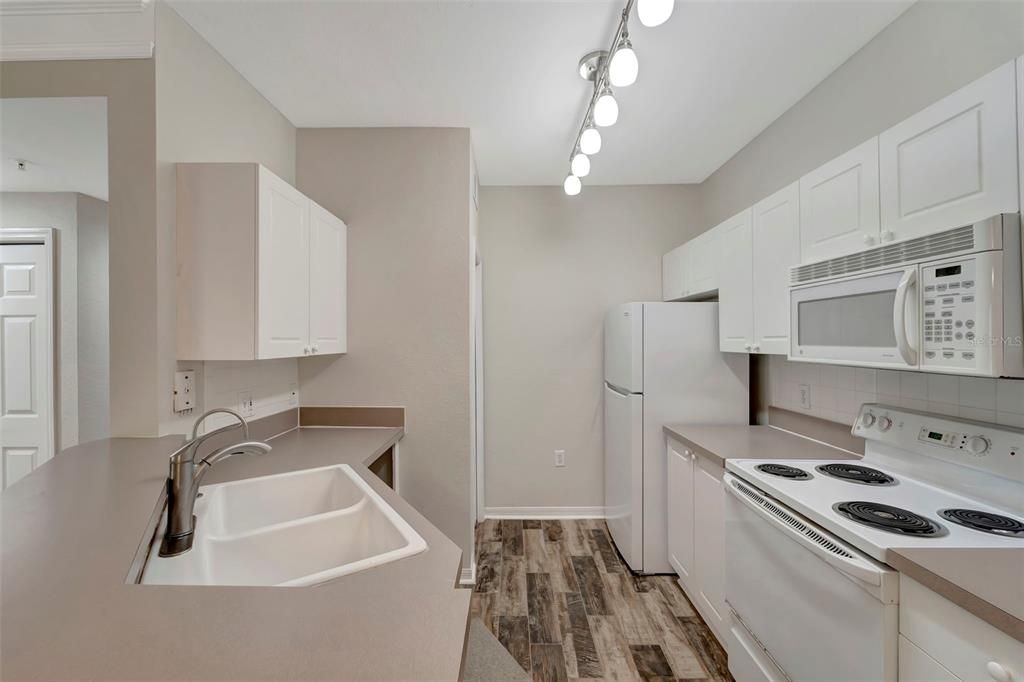 Kitchen has newer flooring and lots of cupboard space