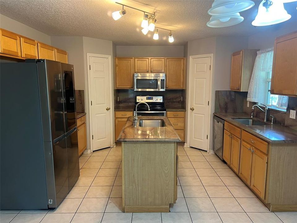 Kitchen with granite counter tops, stainless steal appliances and double panty