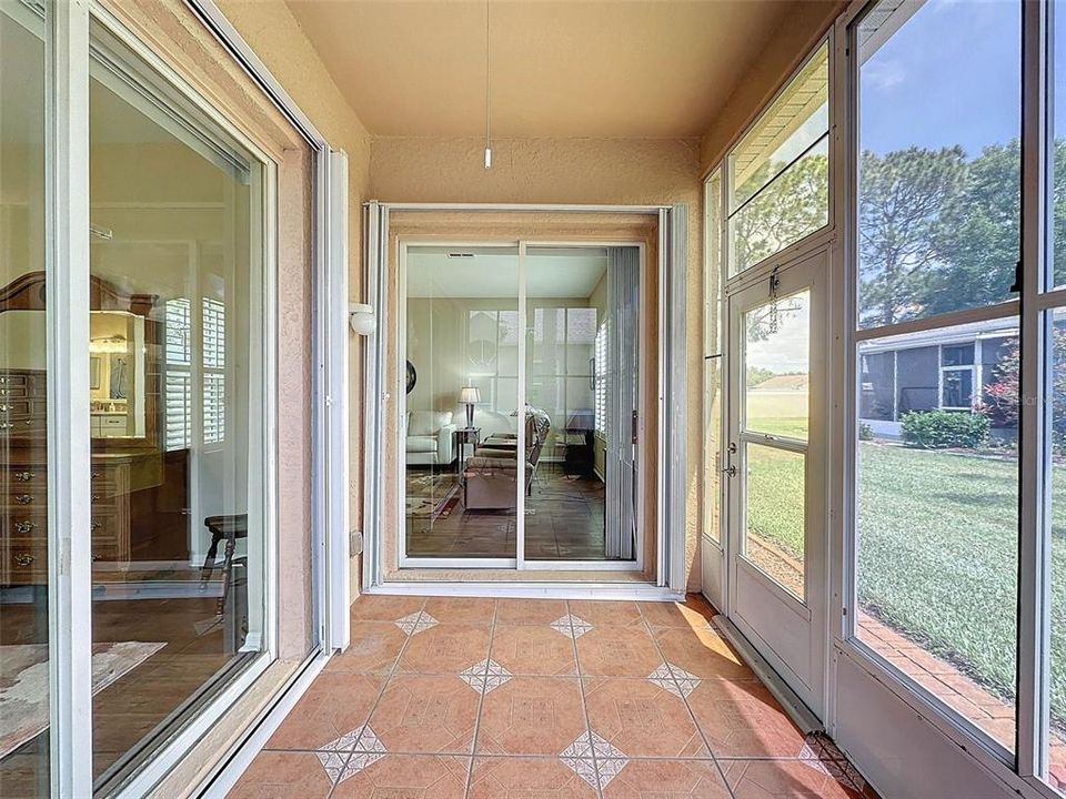 sliding doors from primary bedroom & living room with hurricane shutters
