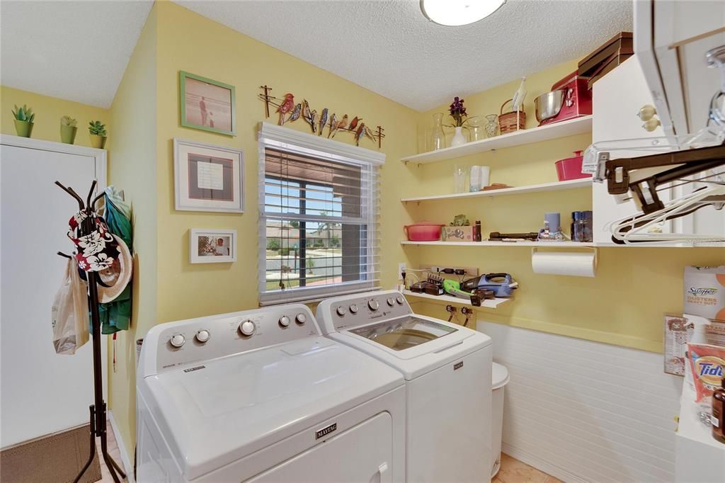 Huge laundry room has a pantry and extra cabinatry