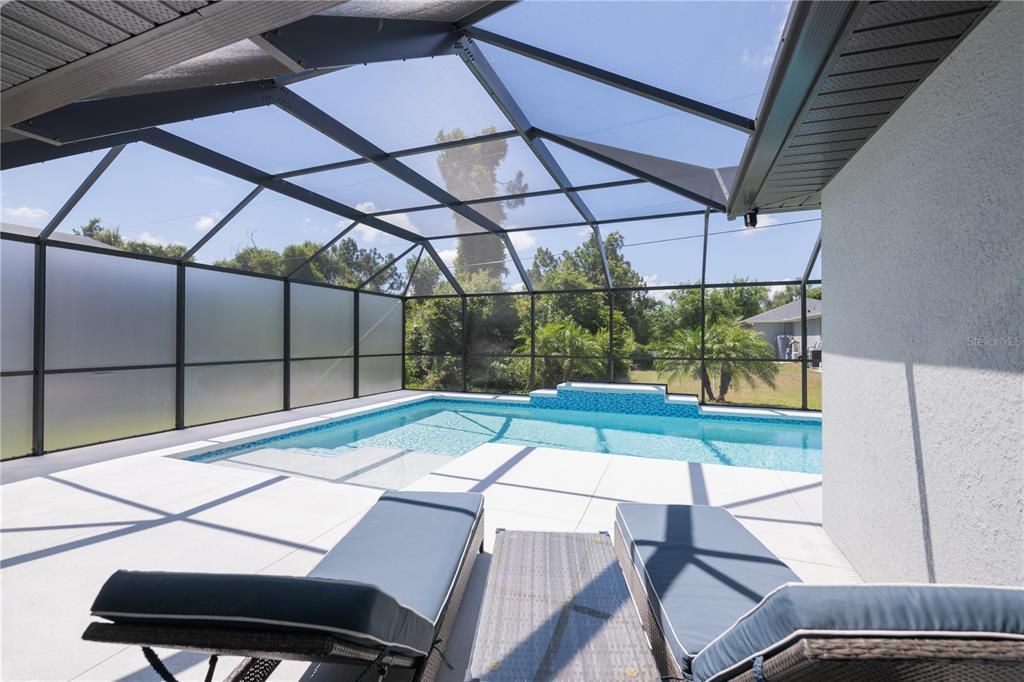 Lots of sunspace on this pool deck with privacy screen wall.