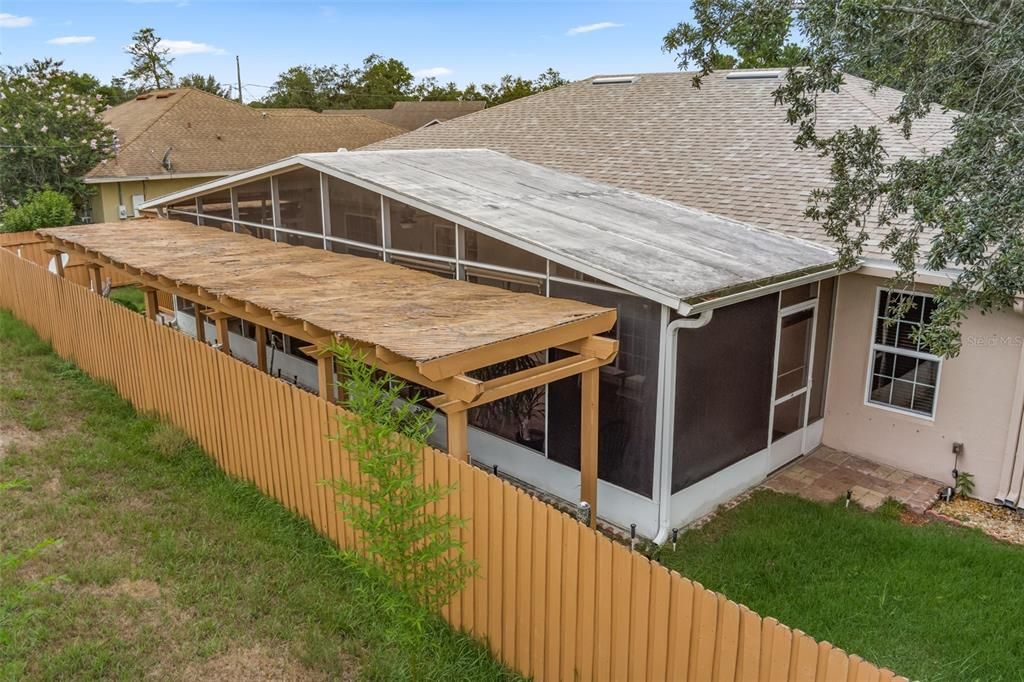 Screened patio and garden area.  The  lot goes beyond this fence.