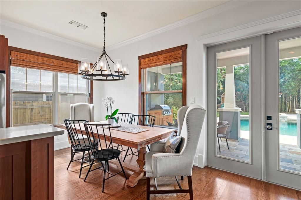 French doors leading to the large backyard with covered porch, outdoor kitchen, saltwater pool and basketball court!