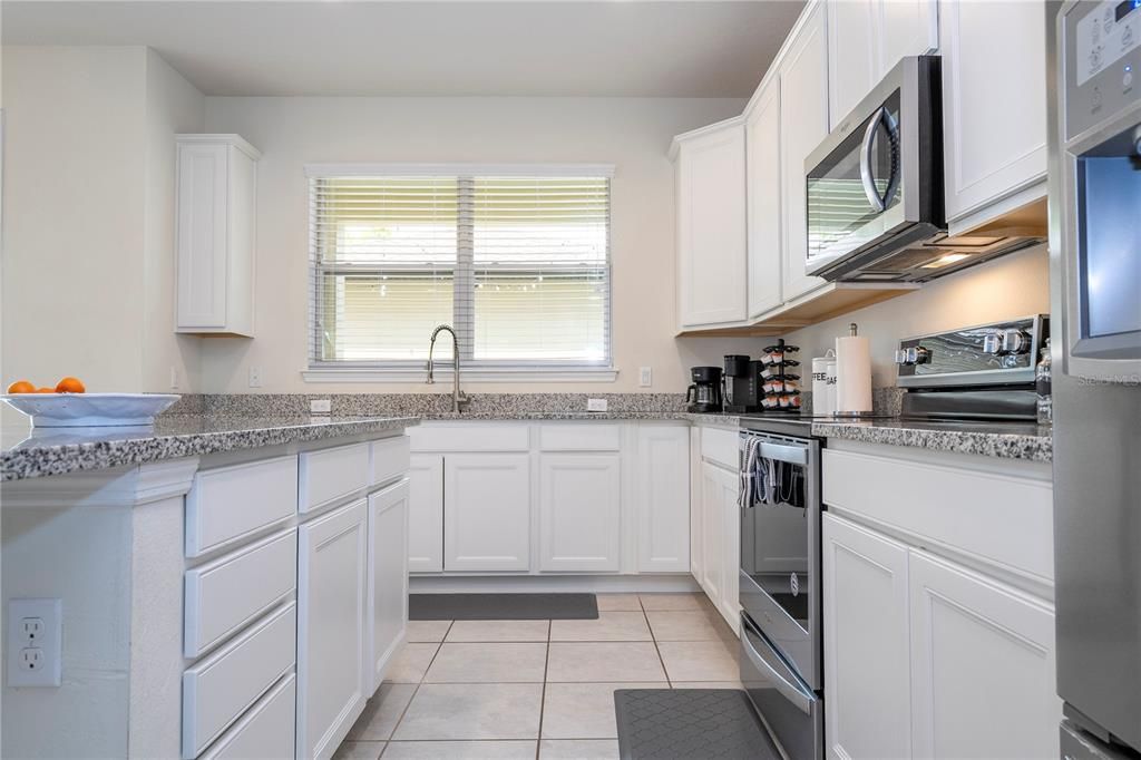 White kitchen and granite countertops.
