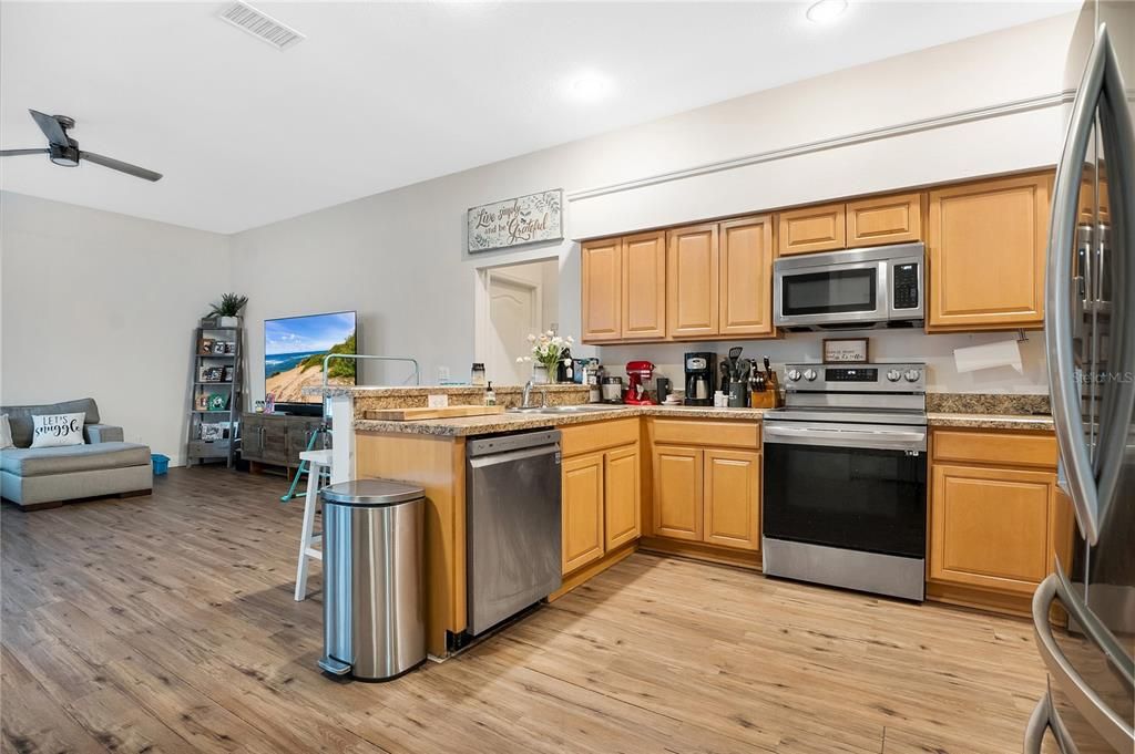 Kitchen with Stainless Steel appliances opens up to the family room