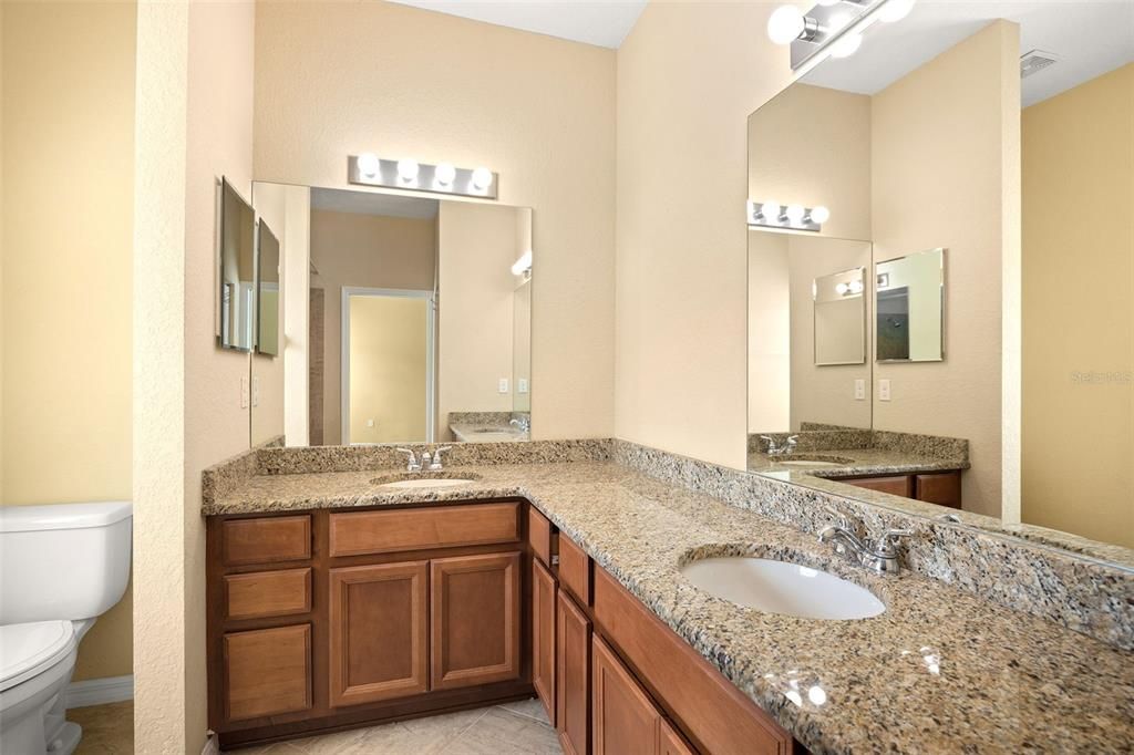 Primary Bathroom With Dual Sinks and Granite Countertops