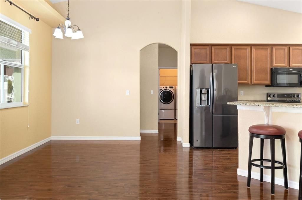 Kitchen and Breakfast Area; Door Leads To Garage, Half Bath, Laundry Room, and Primary Bedroom