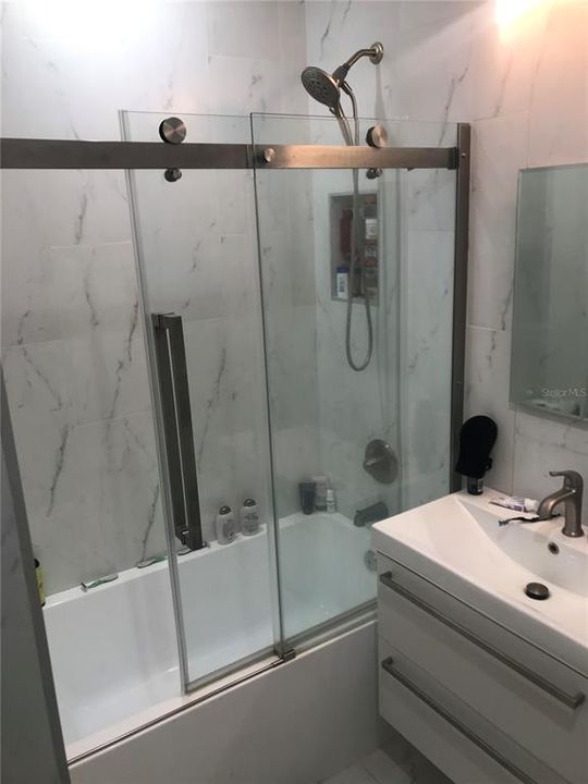 Hallway Bathroom tub shower combo with glass doors
