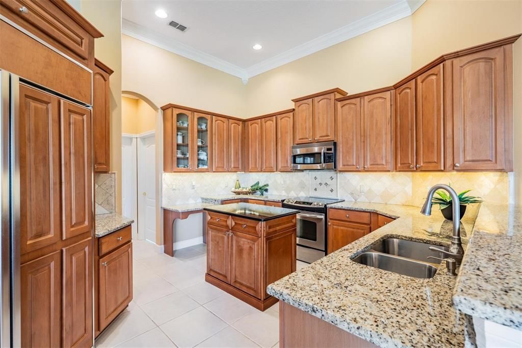 Granite countertops; accented with glass-front cabinets