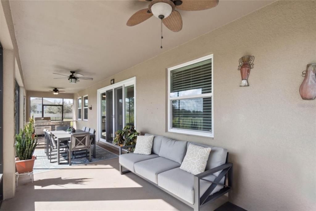 Oversized screened-in lanai to the patio w/ lake view - Staged Photo