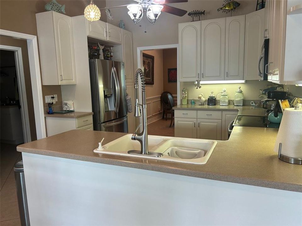 Remodeled Kitchen has Corian counters, updated appliances, lighting & wood cabinets