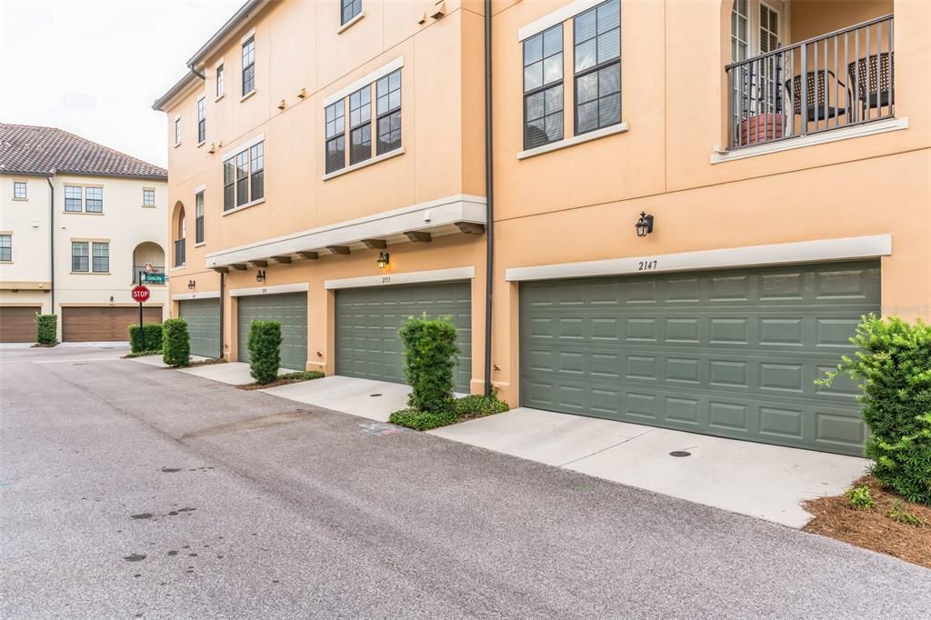 Rear garage entry with nearby guest parking.