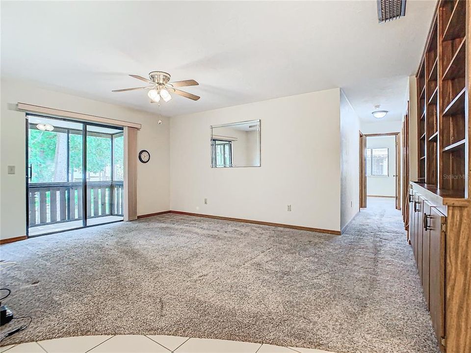 Living room with sliders that open up to the screened-in balcony.